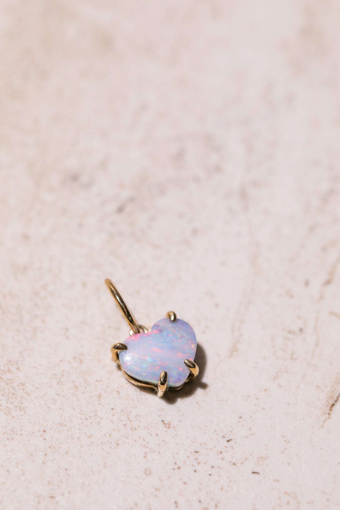 boulder opal 14k charm australian opal 14k gold on background pink red blue stripes