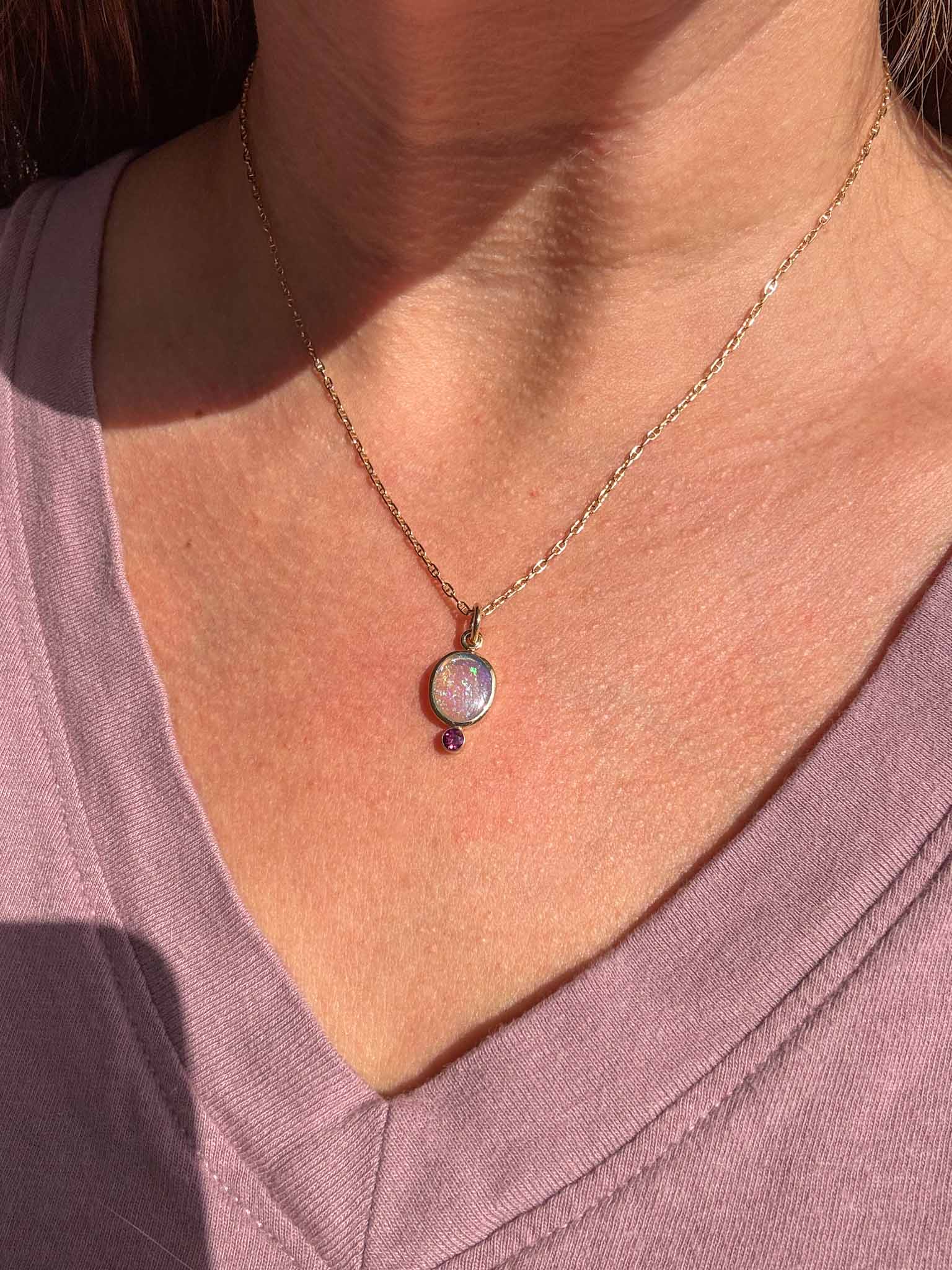 Necklace with a pendant worn by a person, focusing on the necklace.