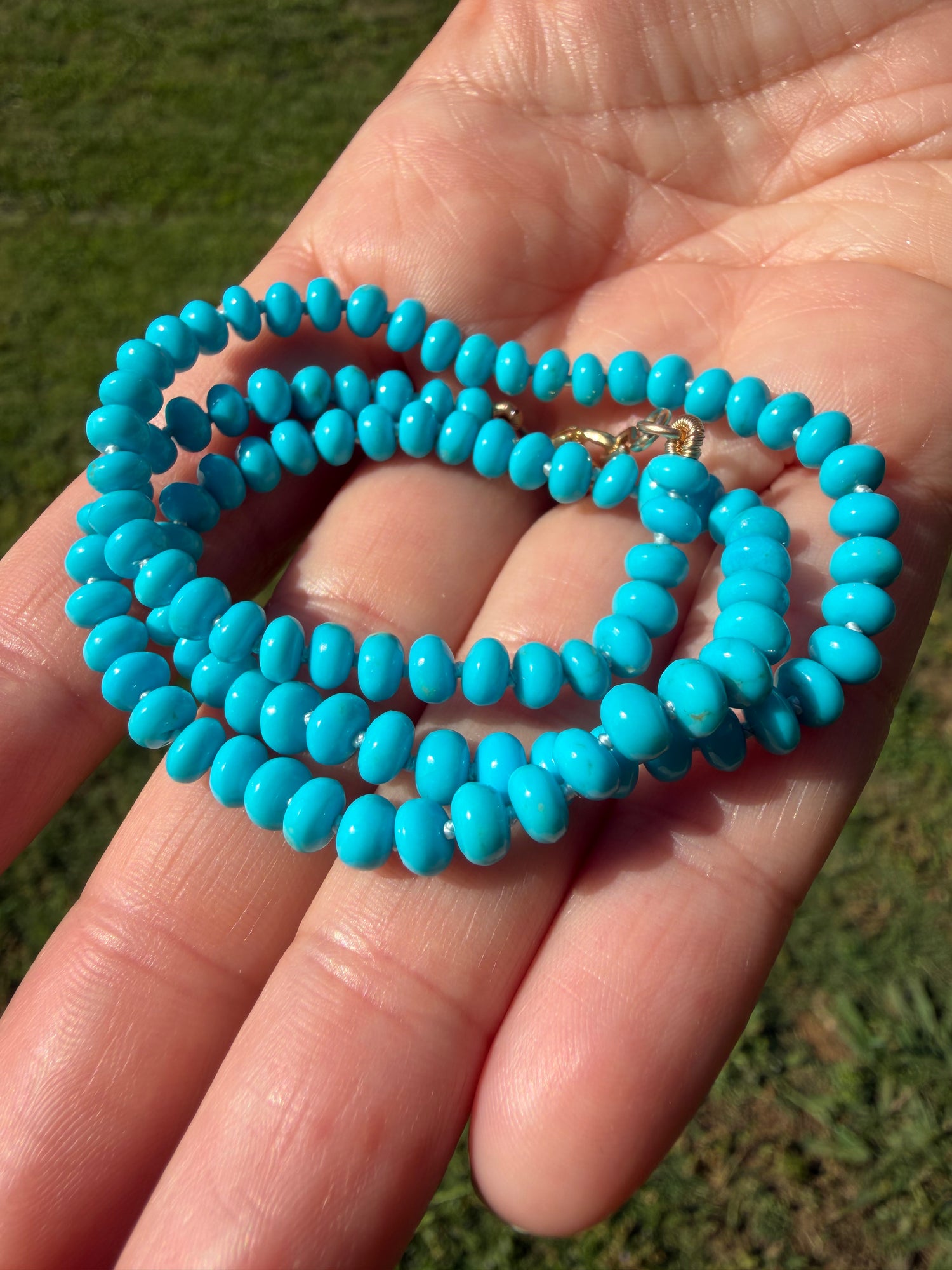 Fine turquoise strand necklace silk knotted rondelle beads solid gold hardware close up detail