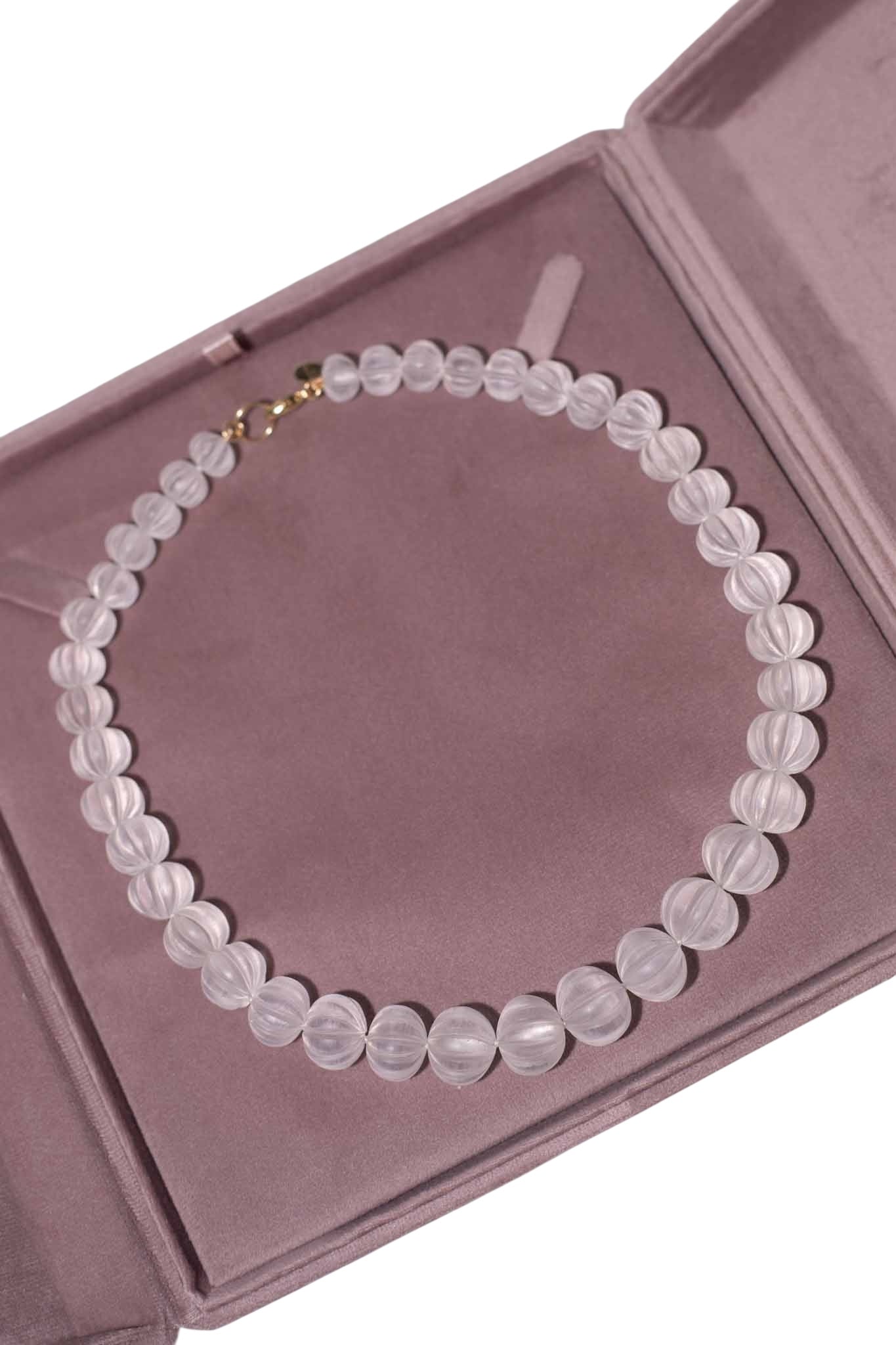 Necklace with white beads on a pink jewelry box Carved Quartz Pumpkins 14k Gold Knotted Candy Bead Necklace