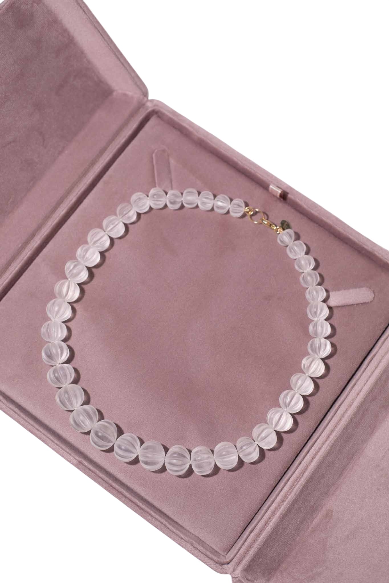 Necklace with round beads on a pink jewelry box Carved Quartz Pumpkins 14k Gold Knotted Candy Bead Necklace
