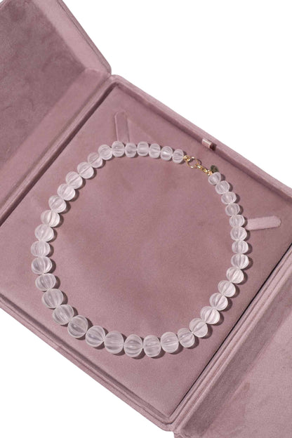 Necklace with round beads on a pink jewelry box Carved Quartz Pumpkins 14k Gold Knotted Candy Bead Necklace
