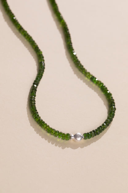 Sterling silver fish set sideways in a faceted chrome diopside strand, view 2