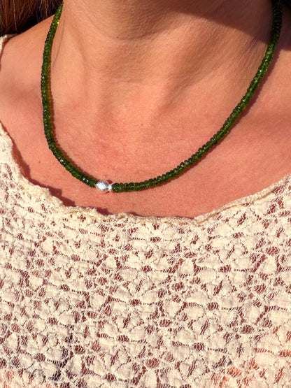 Chrome Diopside Worry Fish Necklace worn at the collarbone with a cream lace top