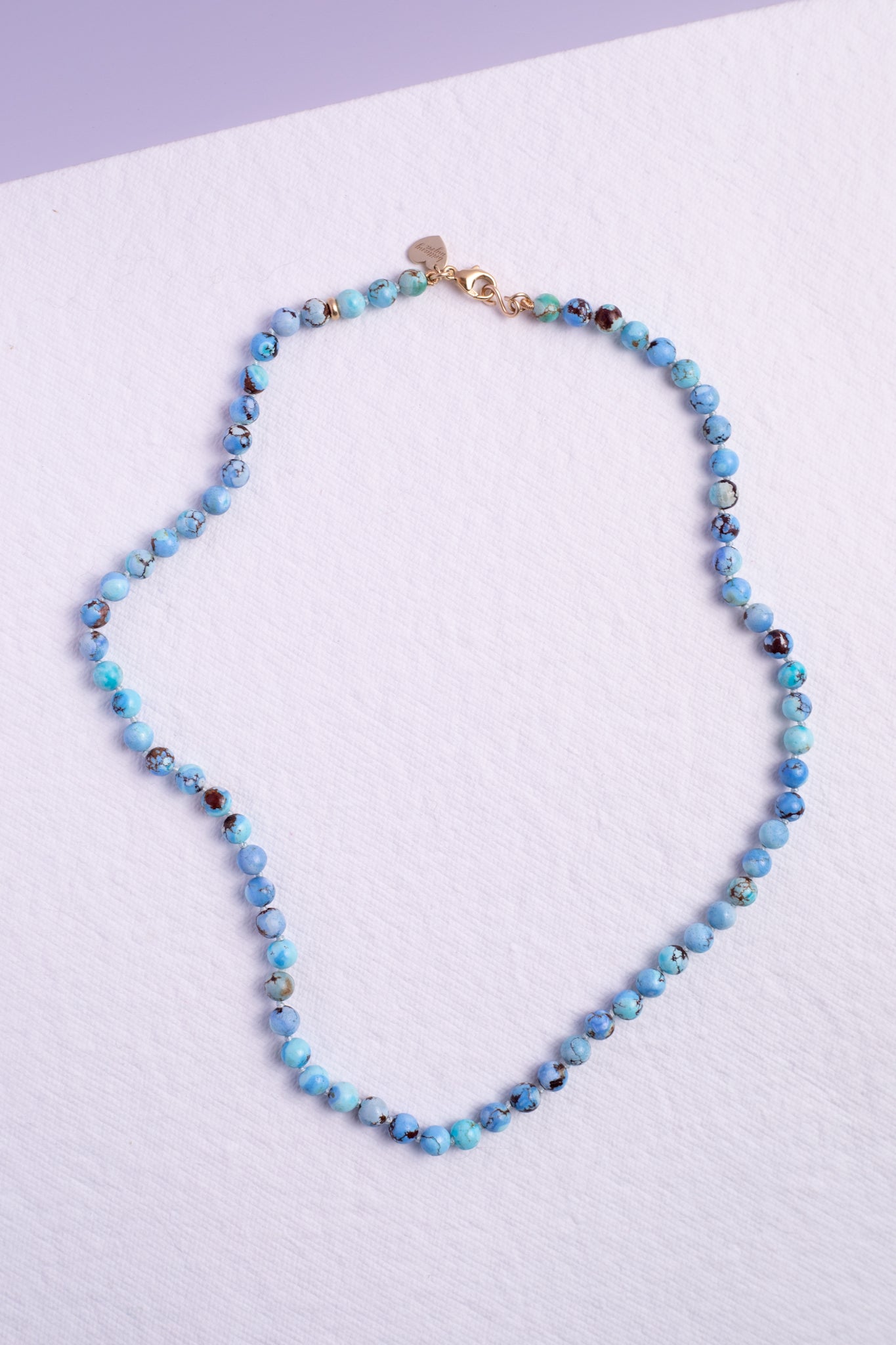 Kazakhstan turquoise knotted strand necklace shown with solid 14k gold lobster clasp