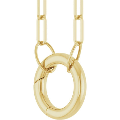 Gold necklace with a large round charm holder on a white background