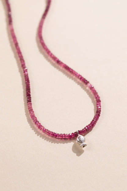 Faceted pink tourmaline strand shading from pale pink to raspberry with a sterling silver Worry Fish, view 2