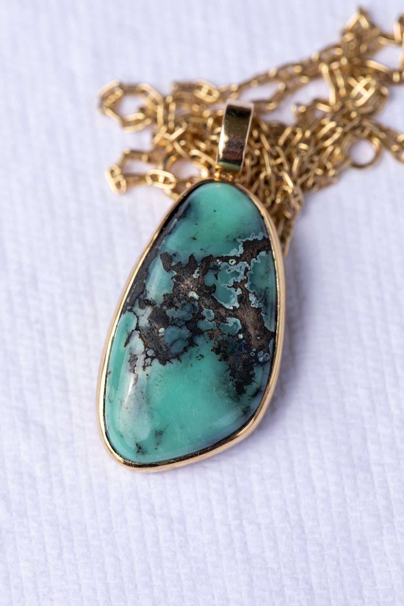 variscite pendant necklace on a white background