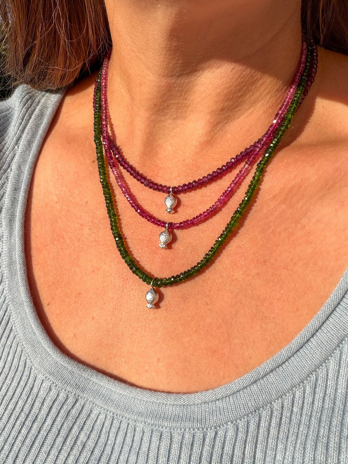 Rhodolite garnet, pink tourmaline and chrome diopside Worry Fish necklaces layered and worn together